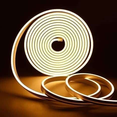 Coiled LED light strip on dark background.