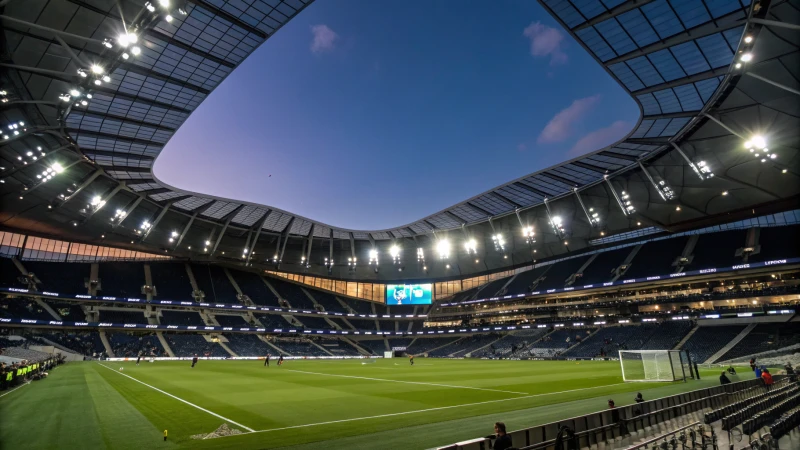 A modern sports stadium at night with bright lights and fans in the stands