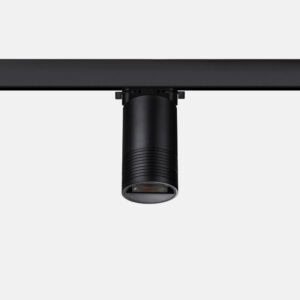 Black cylindrical spotlight on rail system.