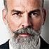 Man with beard and serious expression.