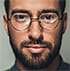 Close-up of person with glasses and beard.